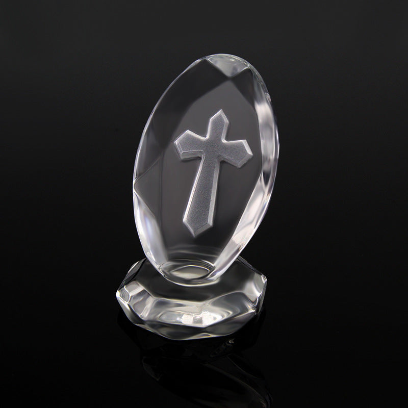 Crystal object with a cross design on a black background