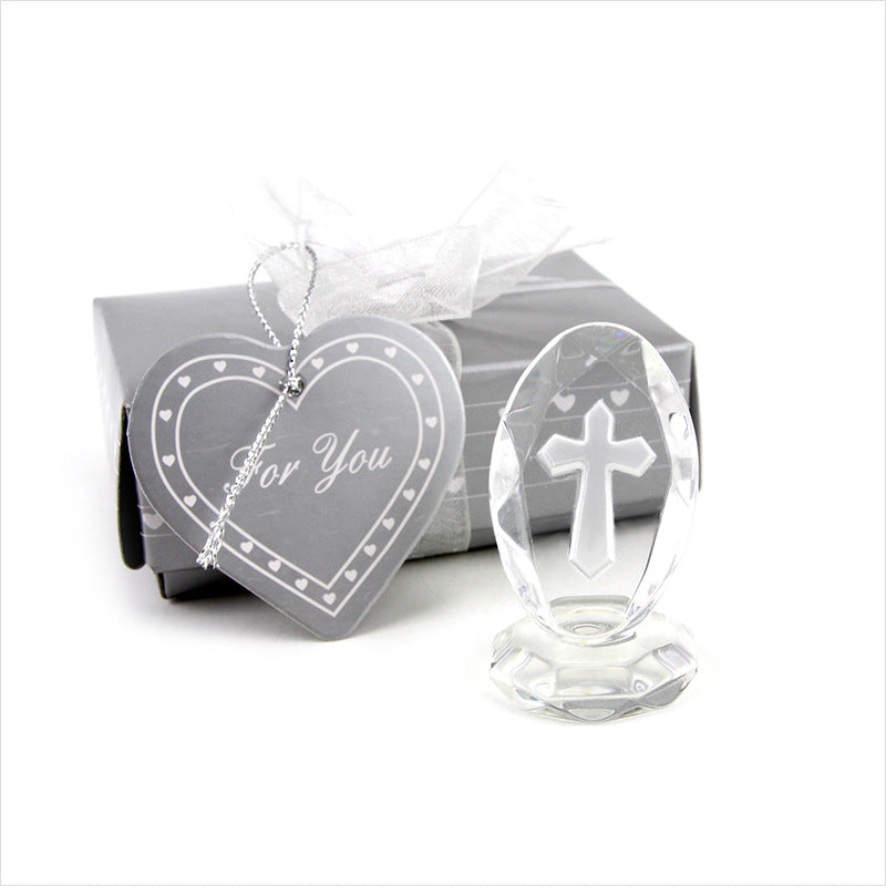 Crystal cross ornament and heart-shaped card with 'For You' text on a white background