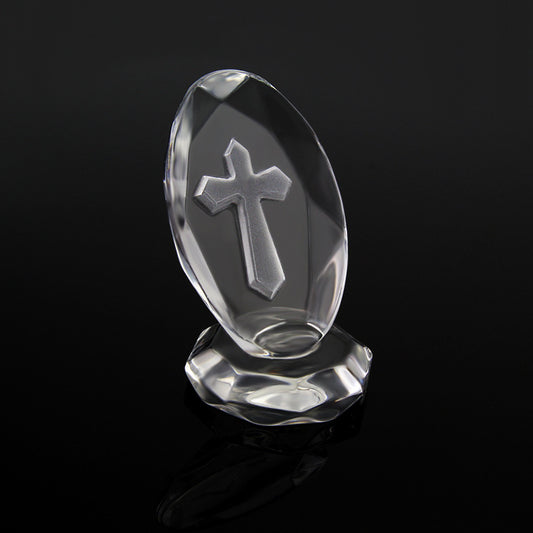Crystal object with a cross design on a black background