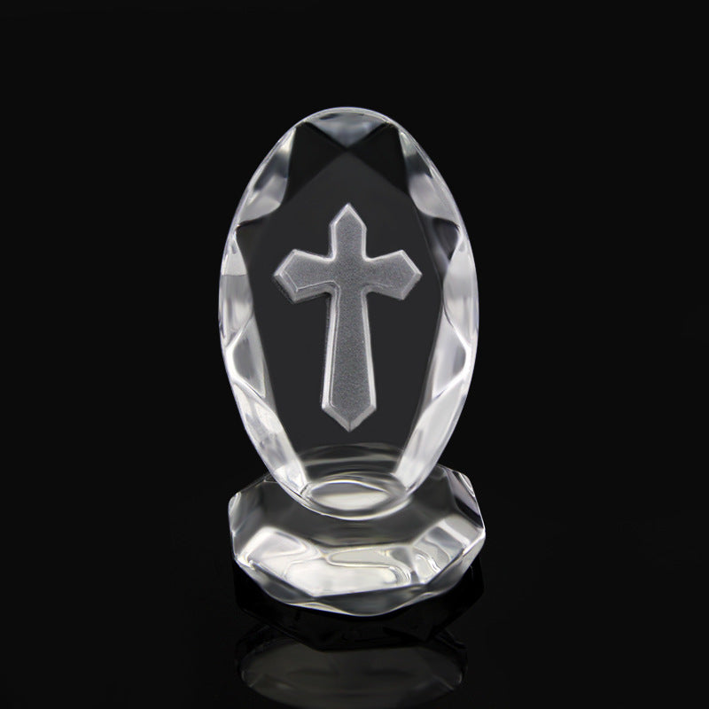 Crystal object with a cross design on a black background