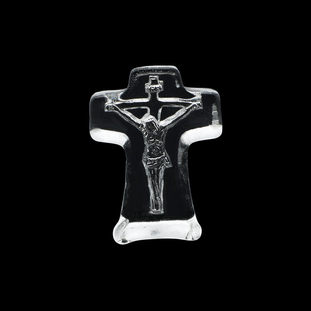 Clear glass crucifix on a black background